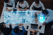 © InfiniteFlow - A professional business team collaborates in a modern office space, discussing cybersecurity strategies, while utilizing digital interfaces to protect their data and enhance productivity. Trope