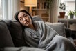 © Meow Creations - Depressed asian woman sitting on sofa under blanket
