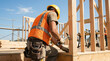 © Mazouni - Worker Builds Wooden Structure With Hammer On Sunn Delpmaspu