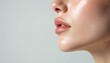 © Pete - Closeup profile view of a woman lips and chin. Smooth skin reflects soft studio light. Natural makeup highlights full pouty lips. Clean aesthetic.
