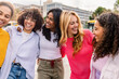 © Xavier Lorenzo - Group of diverse women embracing and laughing together. Young female friends celebrating friendship and happiness outdoors. Unity and empowerment concept.