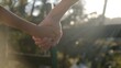 © DawDunia - Child and adult hands holding firmly, symbolizing connection, trust, guidance, care, protection, and the strong bond of family in warm, natural golden light