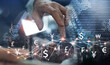 © tippapatt - Currency exchange, money transfer, FinTech financial technology, Global business, online banking, interbank payment concept. Man using mobile phone and laptop computer with international currencies