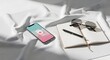 © Alpona Desing Store - Smartphone Notebook and Sunglasses on White FabricOverhead