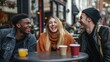 © Maria Vitkovska - Diverse young friends laughing enjoying happy time at an outdoor cafe