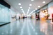 © Iryna - Blurred shopping mall interior with bright lights and reflections