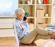 © Lumos sp - Portrait of a mature senior woman or a  businesswoman working from home having a meeting online, home office, or a student learning, or mature woman having a phone call, holding a mobile phone, smartp
