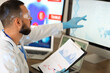 © Pixel-Shot - Male doctor analyzing scientific data at desk in laboratory