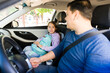 © AntonioDiaz - Dad dropping off daughter at school, student wearing backpack in car, family morning routine education