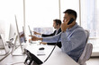 © fizkes - Customer support workflow. Diverse multiethnic staff of modern call center technical assistance desk telecom service centre manage real time client calls sitting by monitors in open space urban office