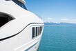© Meow Creations - Sleek white modern luxury yacht exterior design with mountain background