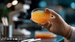 © Jane_S - Lab technician holding culture plate in microbiology lab