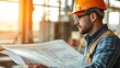© Tom - drafting. Architectural blueprint on a drafting table with a professional in safety helmet, set against a construction site backdrop. real-estate listings.