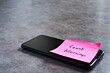 © Shannon Muranyi - 'Count blessings' sticky note left on smartphone. The bright note stands out against the keys, symbolising motivation, productivity, and a focused mindset.