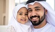 © rehan - A smiling father and daughter in traditional Middle Eastern attire.