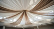 © Polina - Elegant wedding ceiling draping with white fabric in a spacious event hall