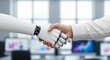 © Olga Ко - Close-up of a handshake between a robot and a businessman in an office: concept of a successful interview, closing a deal, future HR management and hiring the best candidate using artificial
