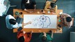 © InfiniteFlow - A diverse group of professionals engages in a brainstorming session, highlighting the role of artificial intelligence in their strategic planning and teamwork efforts. Raster