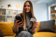 © Zoran Jesic - Woman shopping online using smartphone and credit card