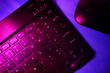 © ADDICTIVE STOCK - Vibrant neon lighting on keyboard and mouse interface