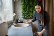 © Zoran Jesic - Woman rinsing glasses under running water in kitchen
