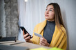 © Zoran Jesic - Woman thinking during online shopping with smartphone