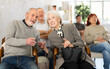 © JackF - Smiling elderly women and men in casual clothes listening to speaker lecture while sitting in office