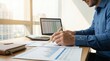© jahidmoon026 - Businessman analyzing financial data at modern office desk with laptop