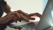 © tippapatt - Close up of woman hand typing on laptop in soft natural light, remote work, online business concept