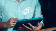 © chaylek - A person using a tablet with AI workflow icons, documents, checkmarks, and automation gears, representing smart document processing, AI-driven approval systems, and digital efficiency solutions.