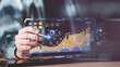 © chaylek - digital marketer holds a pen pointing to a data-driven graph, SEO concepts, optimization analysis tools, search engine rankings, insights from social media platforms based on performance data.