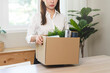 © Pormezz - unemployed concept, employee clear her stuff at office to move out after get layoff from company in recession.