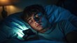 © Olya - person lying in bed at night holding a smartphone, blue screen glow on pillow and t-shirt, warm bedside lamp, late-night scrolling and sleepy, contemplative mood