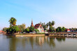 © frenta - Bridge leading to Buddhist temple Saphan Boon Wat Traphang Thong on island, Sukhothai, Thailand. Picturesque landscape with temple in middle of lake, Sukhothai. Topic of vacation, travel, trip, cruise