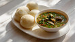 © Slamet Creative - A round plate of Fufu with fish broth on a blurred background. Illustration of traditional Nigerian food background.