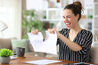 © PheelingsMedia - Happy self employed breaking paper contract working at home