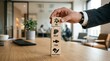 © Farida - Professional hand carefully stacks wooden blocks representing food groups for dietary planning in a modern office