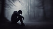 © rcomp - Man Sitting Alone in Dark Forest.