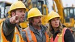 © ЮРИЙ ПОЗДНИКОВ - Caucasian construction workers, two young adults and one middle-aged man with fair skin, wearing yellow hard hats and safety vests point at a site.