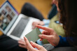 © Studio Marmellata - A person holds a payment card in front of a laptop, ready to make an online purchase.