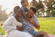 © Sabrina - Happy multiracial family having tender moment at city park during spring season - Pregnancy, childhood and love concept
