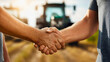 © RaeLi - Farmers shaking hands in front of green tractor, successful agricultural machinery sale, farming business deal, buying new equipment, agribusiness partnership.