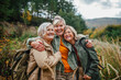 © Halfpoint - Group of mature female friends enjoying countryside walk.
