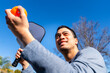 © Christine La/Stocksy - Man playing pickleball outside