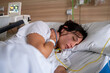 © Bisual Studio/Stocksy - Exhausted Pregnant Woman Lying In Hospital Bed