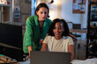 © Jovo Jovanovic/Stocksy - Two women collaborate on a laptop in an office.