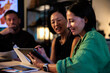 © Jovo Jovanovic/Stocksy - Teamwork, Three people collaborate on a project using a tablet.