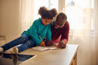 © Boris Jovanovic/Stocksy - Father helps his child with homework