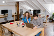 © Adrian Rodd/Stocksy - Self-employed individuals working remotely in an indoor environment