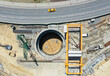 © A I E/Stocksy - Aerial View of Deep Construction Shaft, Giant Crane and Urban Road